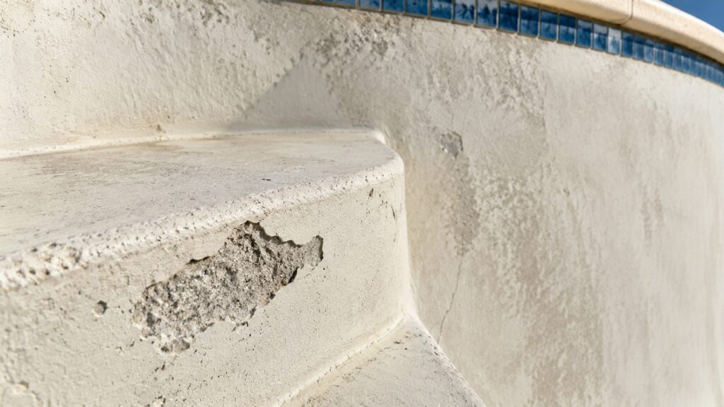 Pool stairs with cracks and flakes